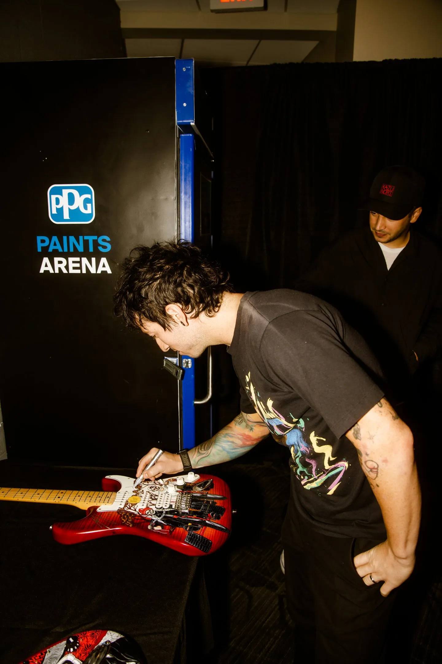 Josh Dun signing painted guitar