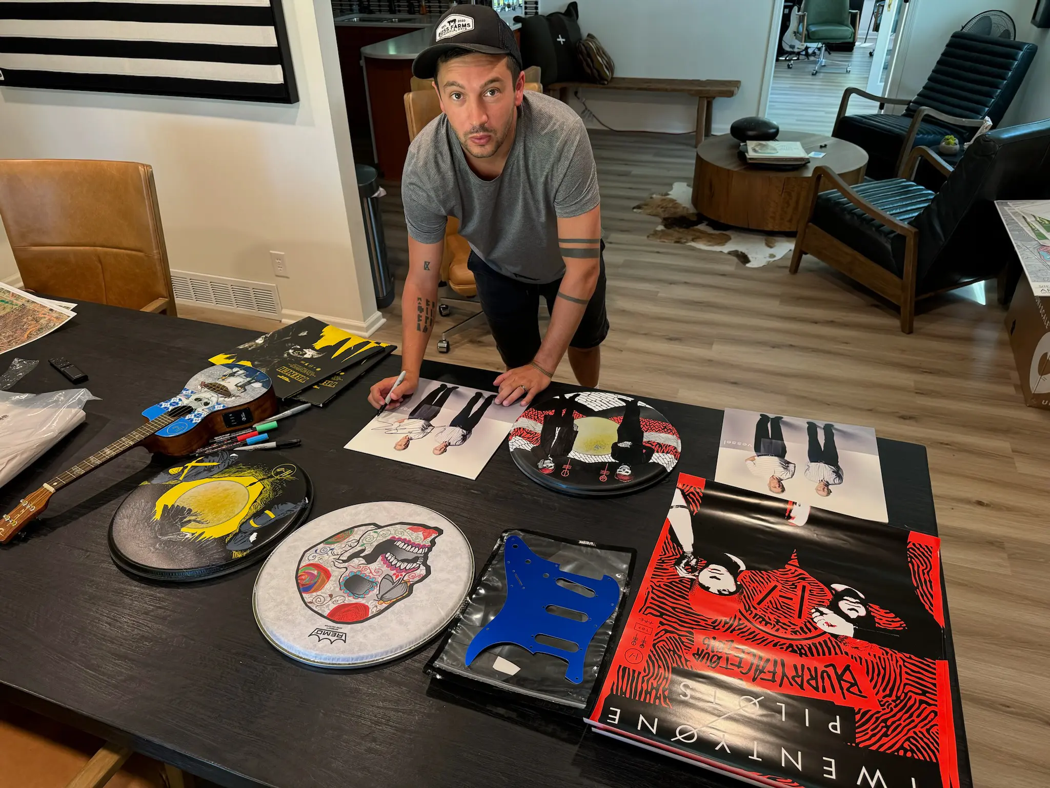 Tyler Joseph signing painted guitar